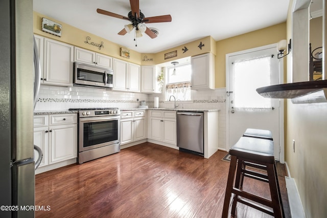 17B Drake St, Whiting, NJ 08759 - kitchen featuring appliances with stainless steel finishes, tasteful backsplash, ceiling fan, dark wood-style flooring, and light stone counters