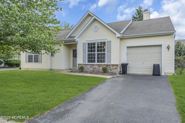 ranch-style house featuring a garage, a chimney, a front yard, and driveway