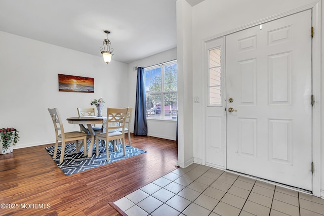 foyer entrance featuring baseboards and wood finished floors