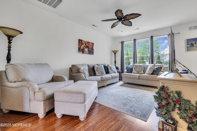 living area featuring dark wood-type flooring and ceiling fan