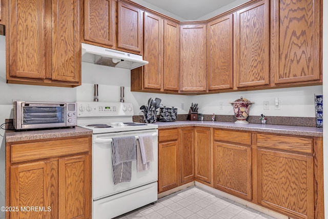 kitchen featuring white electric range, under cabinet range hood, and brown cabinets