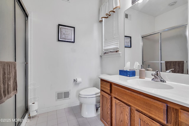 full bath featuring tile patterned floors, a shower stall, toilet, vanity, and baseboards