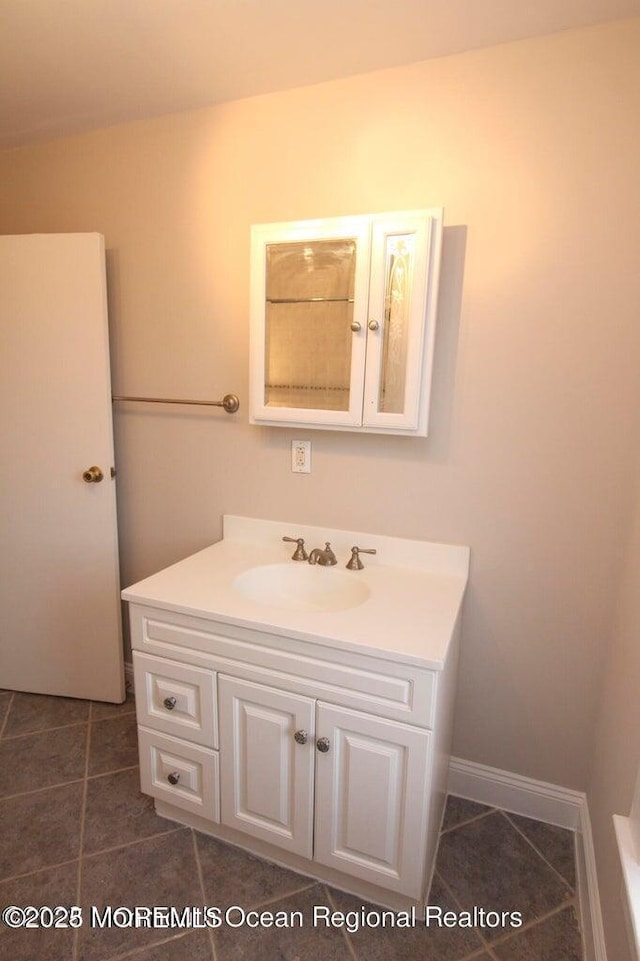 bathroom with tile patterned floors and vanity