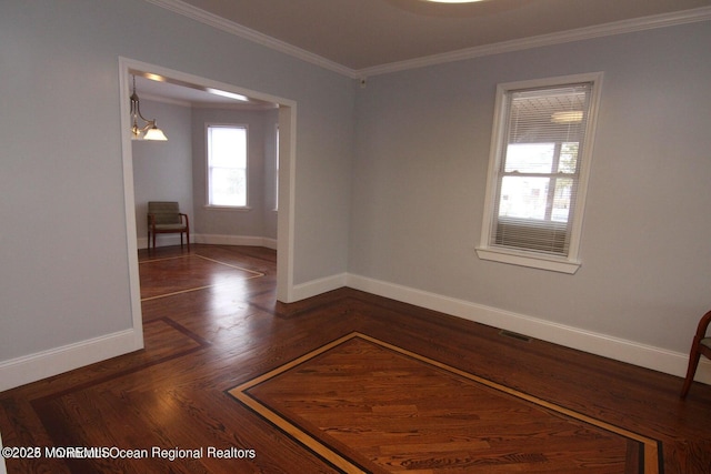 unfurnished room with crown molding and baseboards