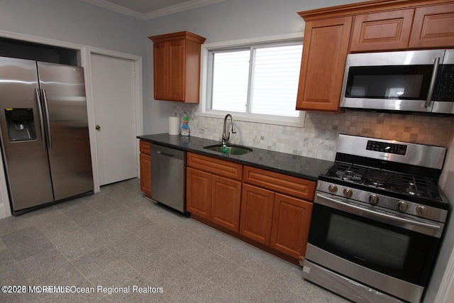 kitchen with appliances with stainless steel finishes, a sink, tasteful backsplash, ornamental molding, and brown cabinetry