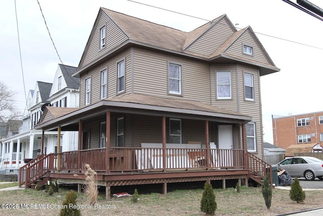 view of front of house with covered porch and roof with shingles