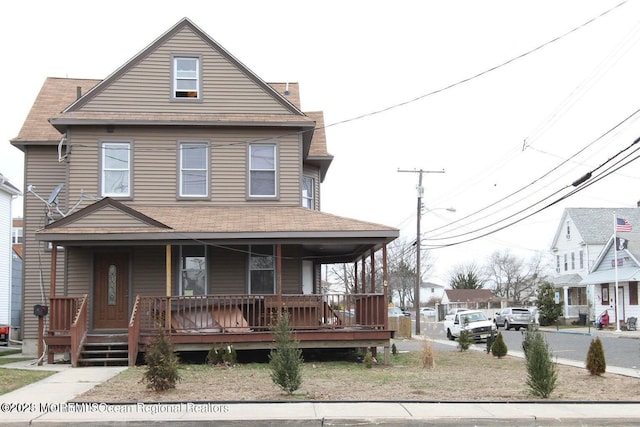 view of front of property with covered porch and a shingled roof