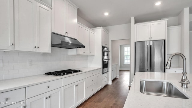 15 Hulse Landing Rd, Brick, NJ 08723 - kitchen featuring stainless steel appliances, under cabinet range hood, a sink, white cabinets, and dark wood-style floors