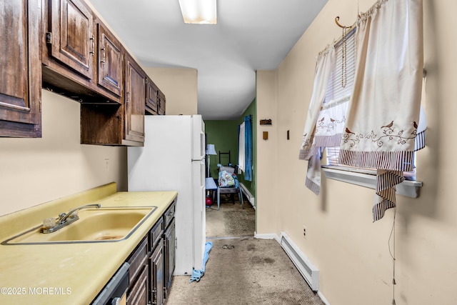 kitchen featuring a baseboard heating unit, a sink, light carpet, light countertops, and dark brown cabinets