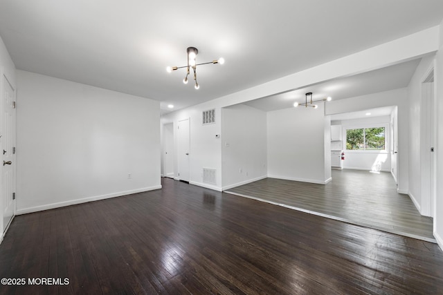 15 Lark Ln, Brick, NJ 08724 - unfurnished living room featuring a chandelier, dark wood-style floors, and baseboards