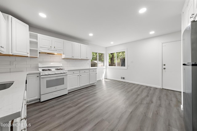 15 Lark Ln, Brick, NJ 08724 - kitchen with white gas range, under cabinet range hood, wood finished floors, recessed lighting, and white cabinets