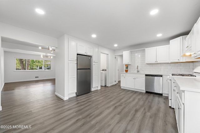 15 Lark Ln, Brick, NJ 08724 - kitchen featuring appliances with stainless steel finishes, washer / clothes dryer, light countertops, light wood-style floors, and baseboards