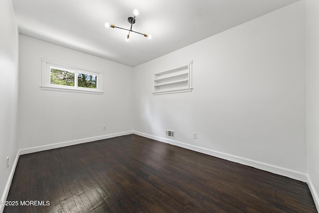 15 Lark Ln, Brick, NJ 08724 - empty room featuring a chandelier, dark wood finished floors, and baseboards