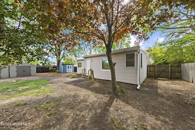 15 Lark Ln, Brick, NJ 08724 - view of front of house featuring a shed, a fenced backyard, an outbuilding, and entry steps