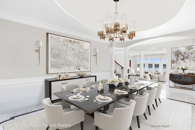 1015 Forrest Rd, Brielle, NJ 08730 - dining room with ornate columns, arched walkways, ornamental molding, a chandelier, and a wainscoted wall