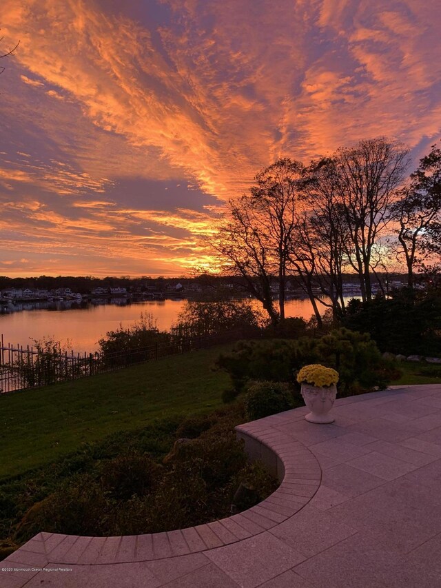 1015 Forrest Rd, Brielle, NJ 08730 - patio terrace at dusk with a water view and a lawn