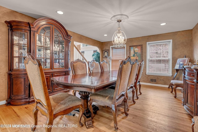 dining room featuring a chandelier, baseboards, light wood-style floors, healthy amount of natural light, and recessed lighting