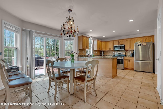 dining space with light tile patterned flooring, a chandelier, and recessed lighting