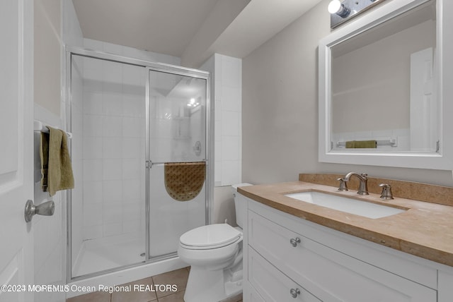 full bathroom featuring a shower stall, toilet, vanity, and tile patterned floors