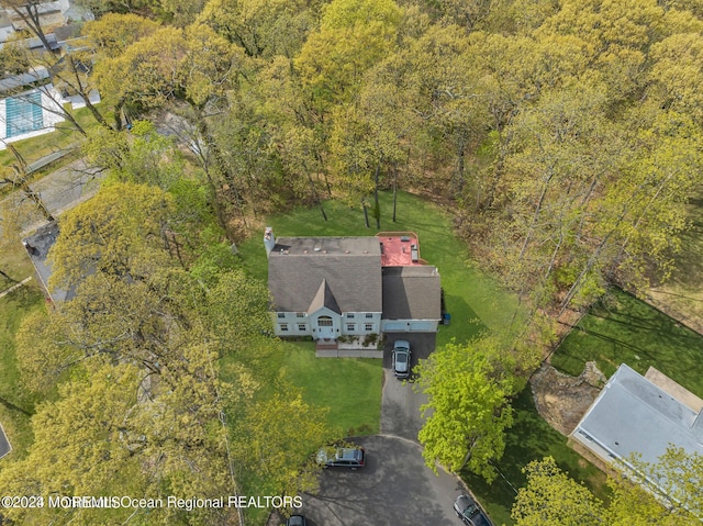 view from above of property featuring a heavily wooded area
