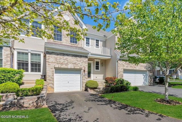 59 Inwood Dr, Manalapan, NJ 07726 - view of front facade featuring driveway, an attached garage, brick siding, and a shingled roof
