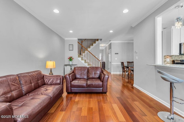 59 Inwood Dr, Manalapan, NJ 07726 - living room featuring light wood-type flooring, recessed lighting, stairs, baseboards, and ornamental molding