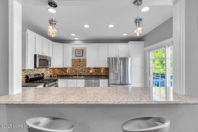 59 Inwood Dr, Manalapan, NJ 07726 - kitchen featuring stainless steel appliances, a sink, decorative backsplash, white cabinetry, and recessed lighting