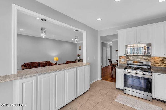 59 Inwood Dr, Manalapan, NJ 07726 - kitchen with appliances with stainless steel finishes, tasteful backsplash, white cabinetry, recessed lighting, and light tile patterned floors