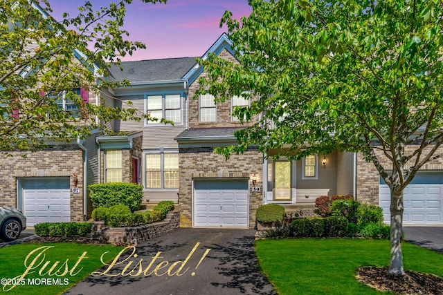 59 Inwood Dr, Manalapan, NJ 07726 - view of front of house with driveway, a front yard, an attached garage, and brick siding