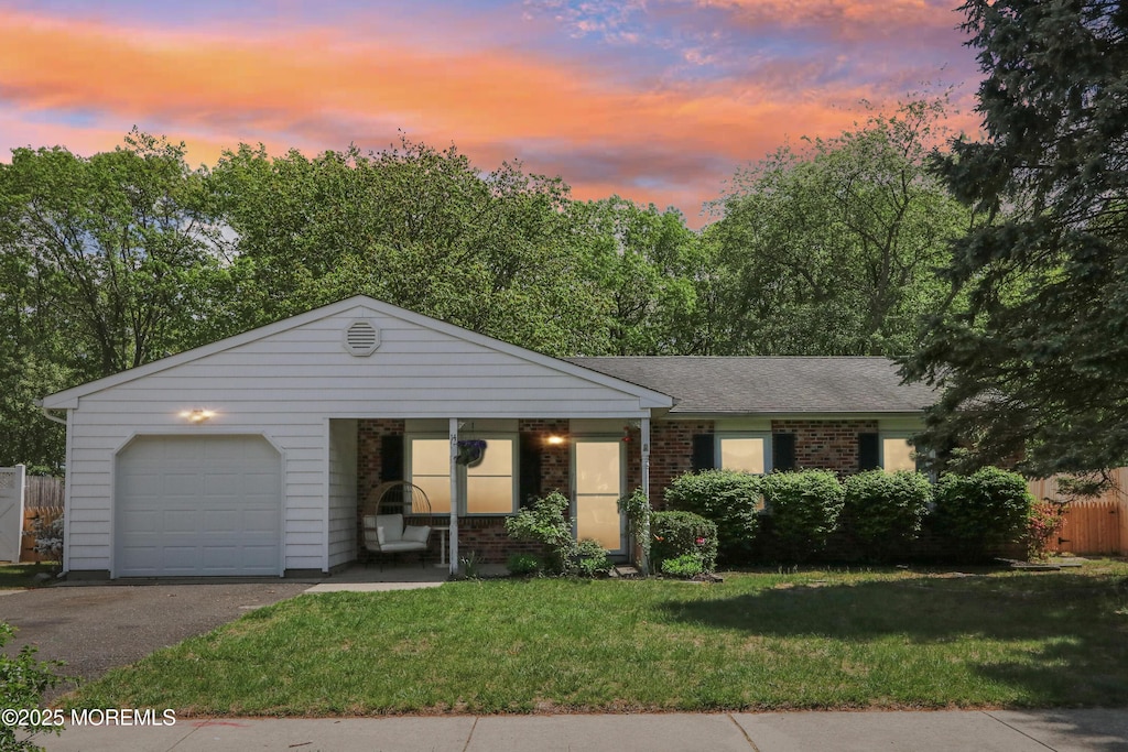 14 Virginia Dr, Howell, NJ 07731 - ranch-style home featuring a garage, a lawn, brick siding, and asphalt driveway