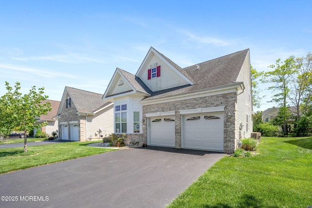 7 Salem Ct, Barnegat, NJ 08005 - traditional-style home featuring asphalt driveway, a front yard, an attached garage, a shingled roof, and stone siding