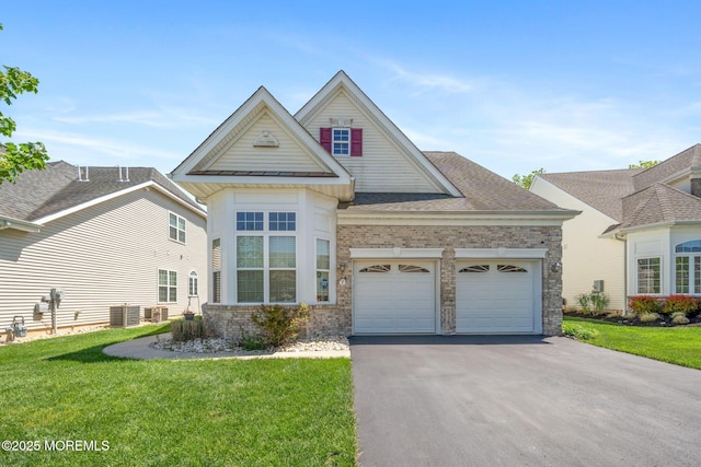 7 Salem Ct, Barnegat, NJ 08005 - traditional-style home featuring asphalt driveway, a front lawn, an attached garage, and brick siding