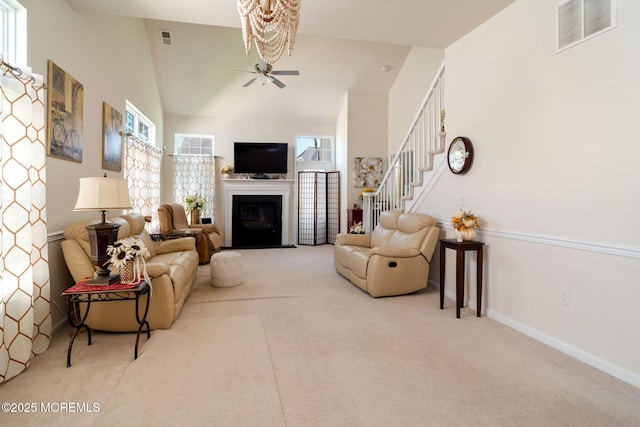 7 Salem Ct, Barnegat, NJ 08005 - carpeted living room with a fireplace with flush hearth, stairs, baseboards, ceiling fan, and high vaulted ceiling