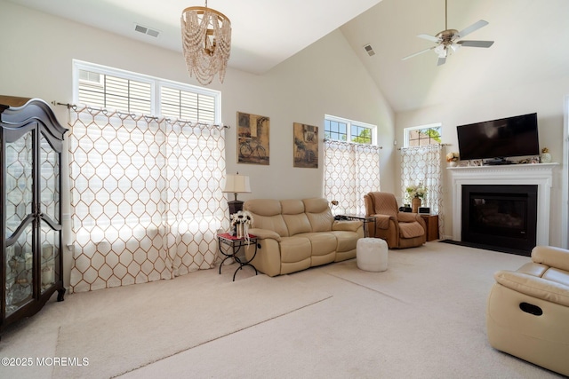 7 Salem Ct, Barnegat, NJ 08005 - carpeted living room featuring high vaulted ceiling, a fireplace with flush hearth, ceiling fan, and a chandelier