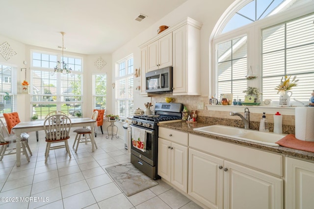 7 Salem Ct, Barnegat, NJ 08005 - kitchen with appliances with stainless steel finishes, a sink, light tile patterned flooring, a chandelier, and decorative light fixtures