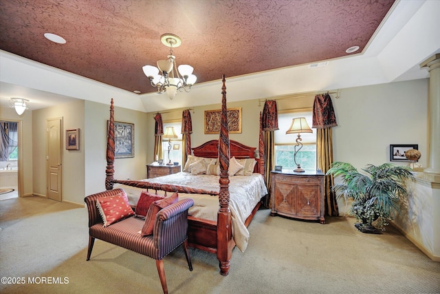 bedroom with carpet flooring, a tray ceiling, a chandelier, and decorative columns