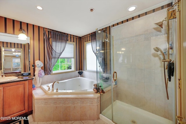 bathroom with a tub with jets, vanity, a shower stall, recessed lighting, and tile patterned floors