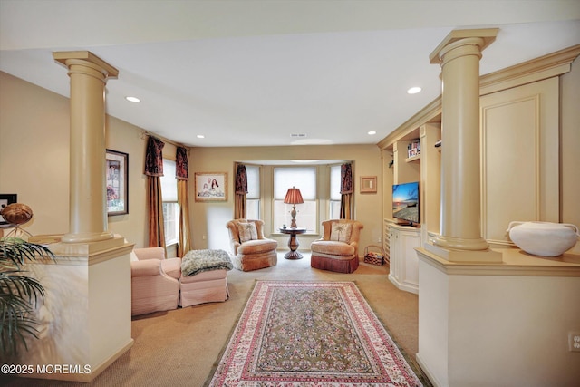 living room with decorative columns, light carpet, and recessed lighting