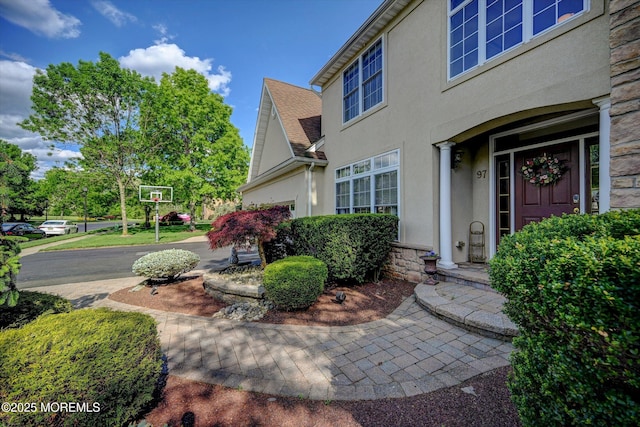 entrance to property with stucco siding