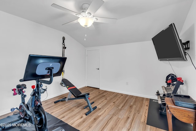 exercise room featuring a ceiling fan, wood finished floors, lofted ceiling, and baseboards
