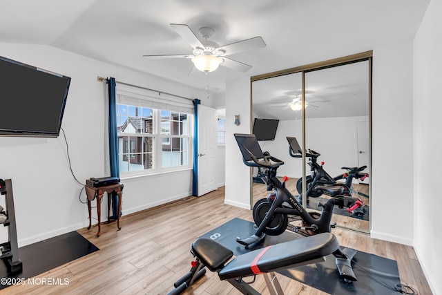 workout room with a ceiling fan, light wood-style flooring, and baseboards