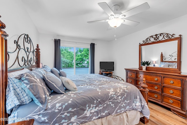bedroom with wood finished floors, ceiling fan, and access to exterior