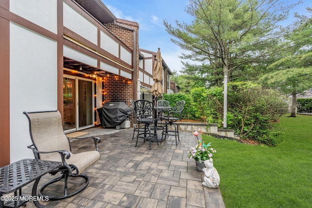 view of patio featuring outdoor dining area and a grill