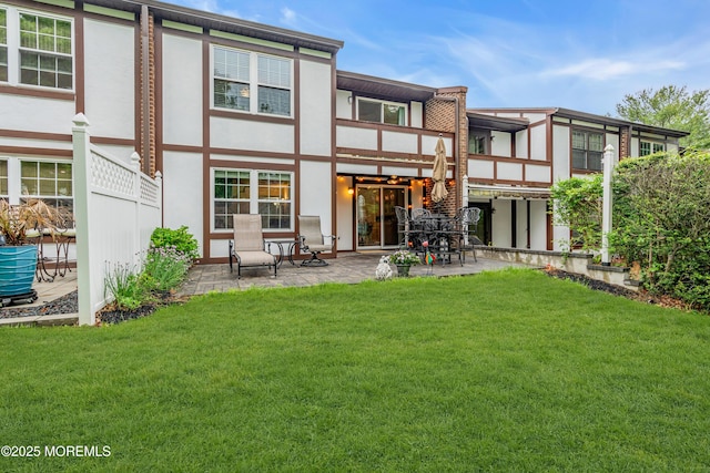 back of property with a patio area, stucco siding, a yard, cooling unit, and a balcony