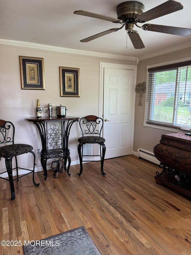 16B Robin St Unit 16B, Manchester, NJ 08759 - dining space with a baseboard radiator, baseboards, crown molding, ceiling fan, and wood finished floors