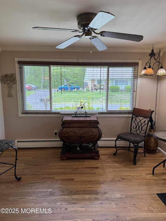 16B Robin St Unit 16B, Manchester, NJ 08759 - sitting room with ornamental molding, baseboard heating, plenty of natural light, ceiling fan, and wood finished floors