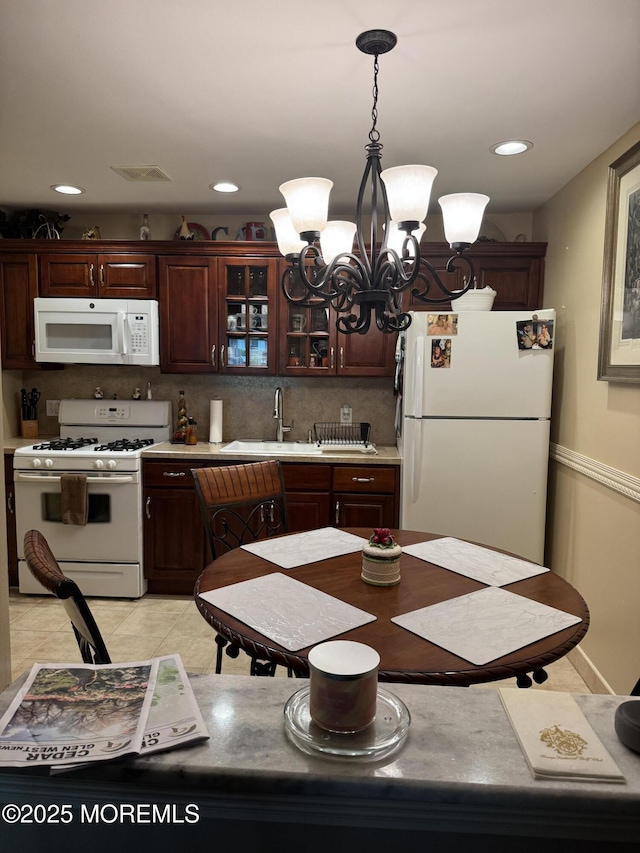 16B Robin St Unit 16B, Manchester, NJ 08759 - kitchen featuring white appliances, a sink, a chandelier, light countertops, and dark brown cabinets