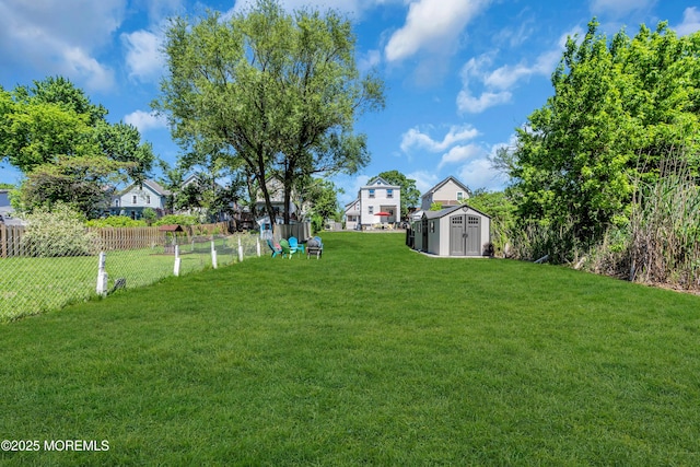 view of yard featuring a storage unit and an outdoor structure