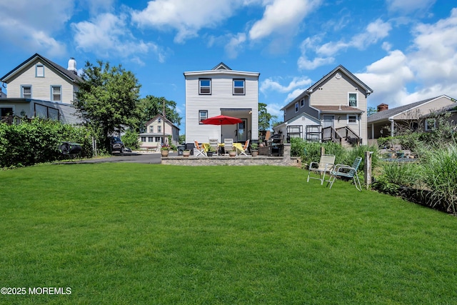 back of property with a lawn and a patio