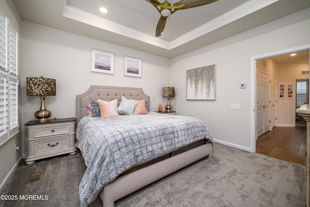 carpeted bedroom with ornamental molding, baseboards, recessed lighting, a raised ceiling, and ceiling fan